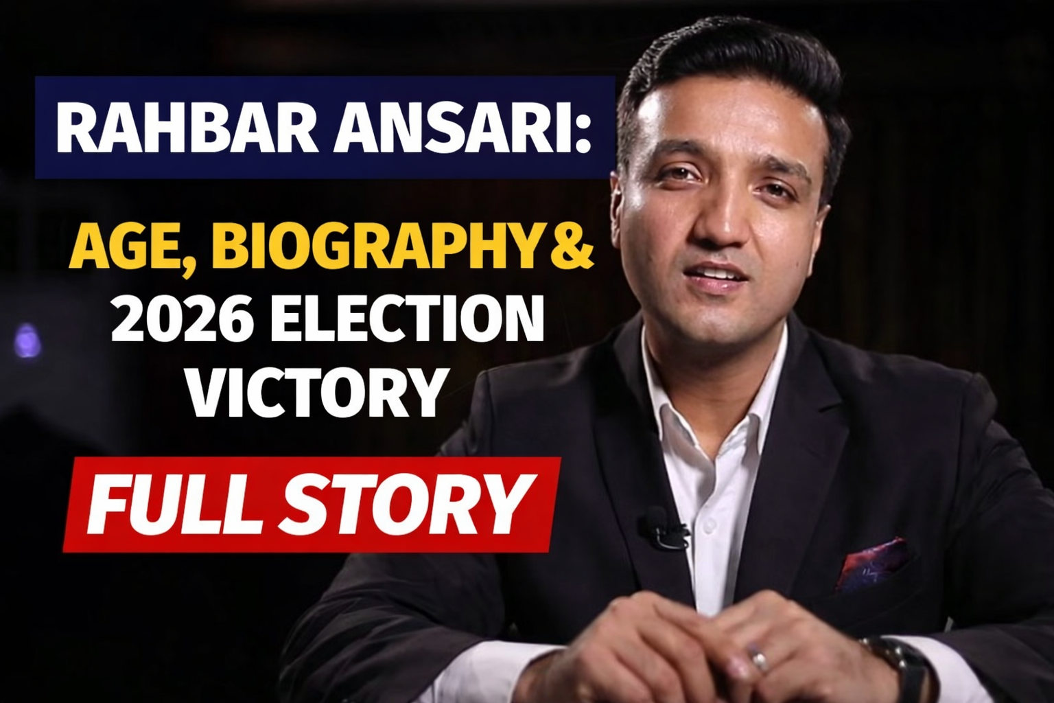 Rahbar Ansari speaking in a formal studio setting wearing a black suit, representing his 2026 election victory and biography